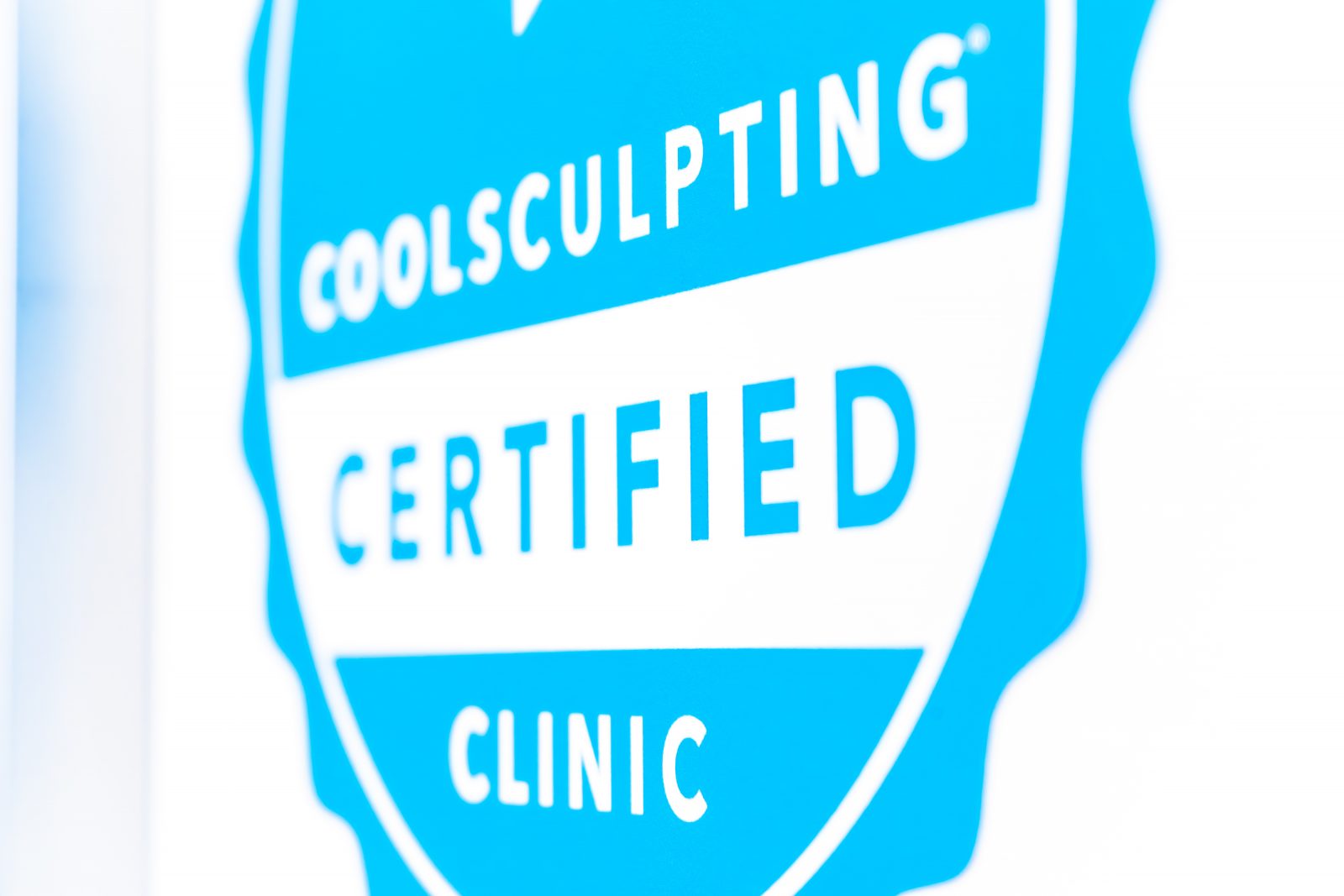 Coolsculpting certified badge decal displayed at a beauty laser clinic offering cryolipolysis cosmetic fat removal.