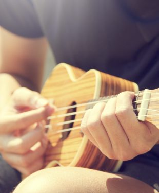 Person playing ukulele