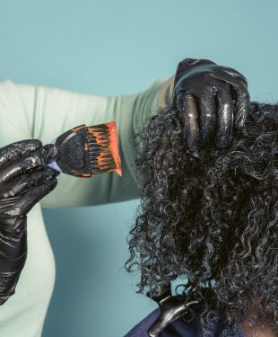 Hairstylist dying hair of black client