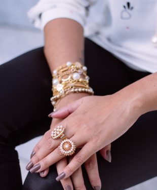 two white pearl encrusted gold-colored rings