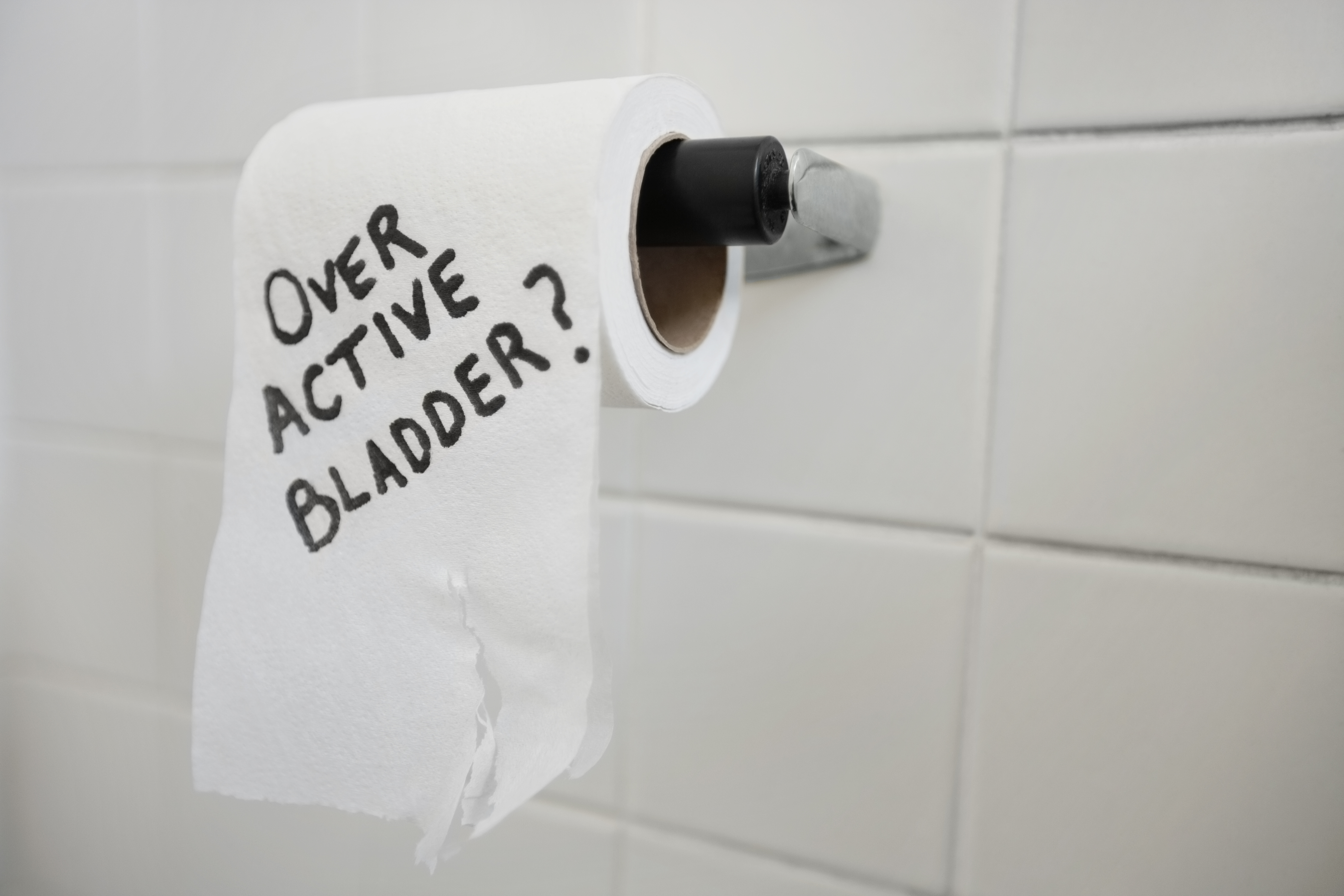 Close-up of toilet paper roll with text asking about bladder issues