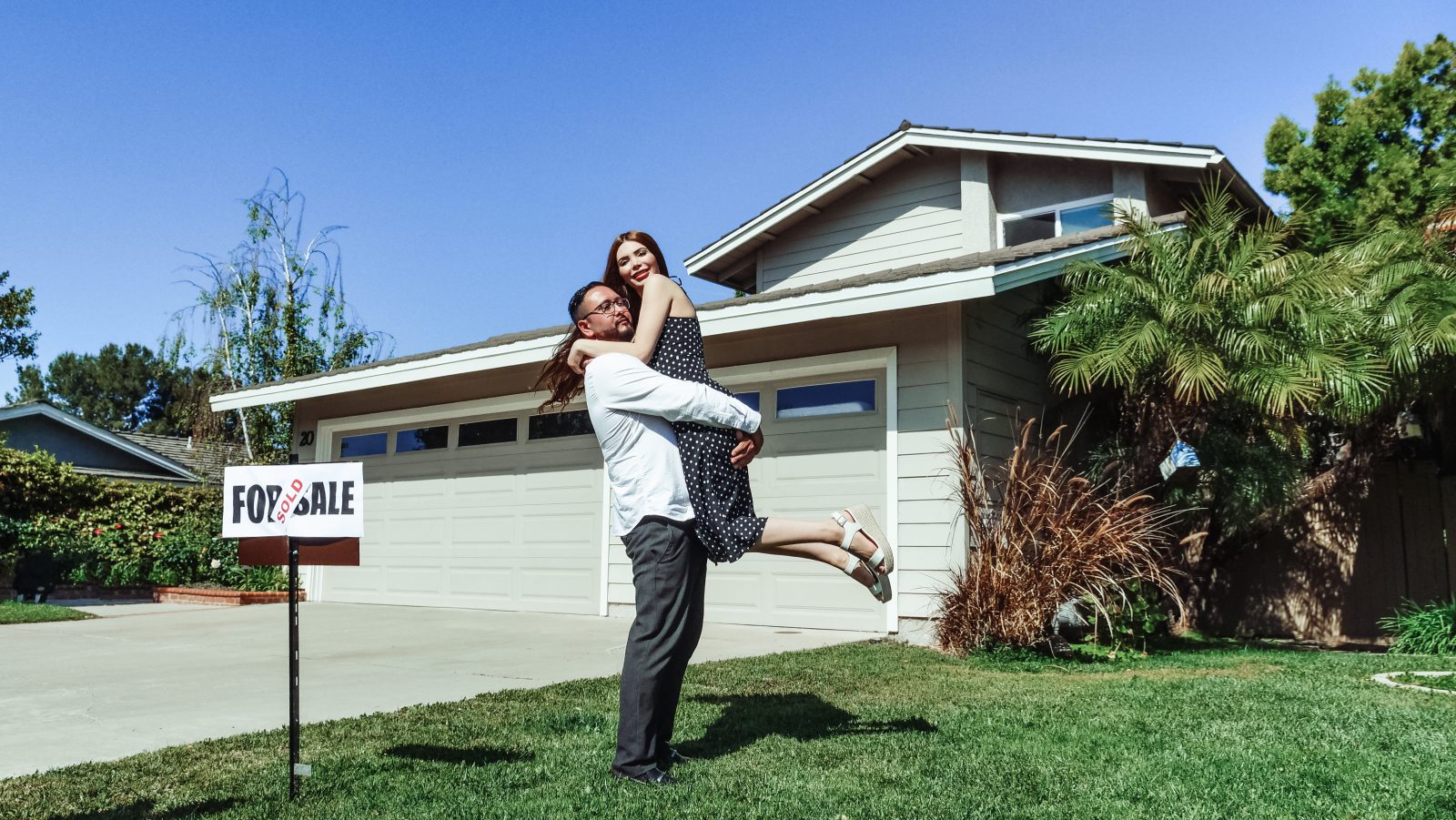 Man and woman in front of their house