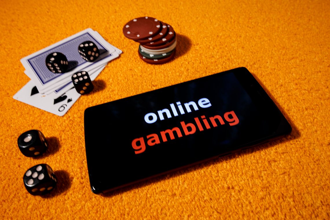 Gambling online with accessories for casinos. In the picture there is a smartphone as a symbol playing to online game.