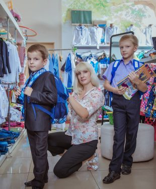 woman buying clothes with the boys in school. Fees for school
