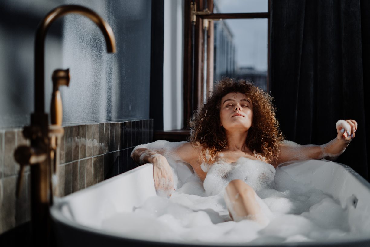 Woman in bathtub with water