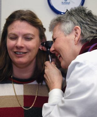 Doctor Examines Patient's Ear
